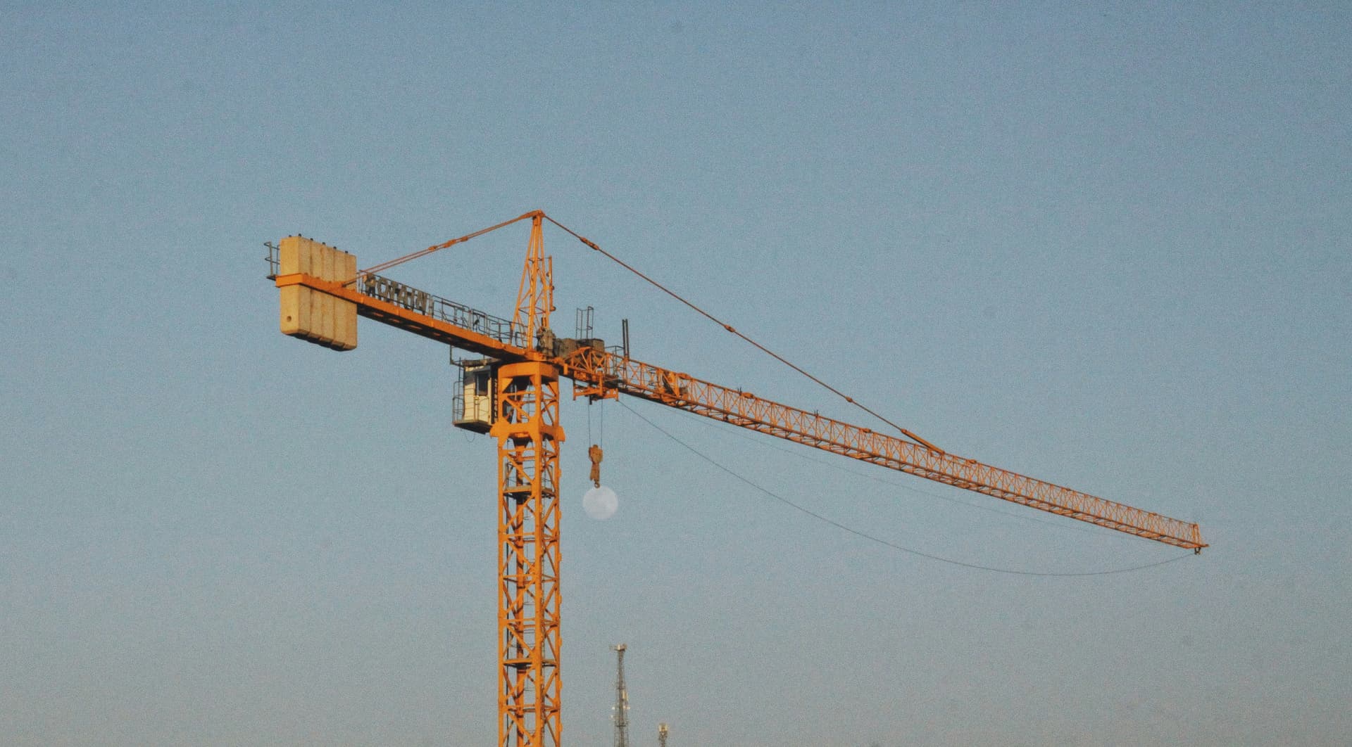 orange crane standing against a blue sky